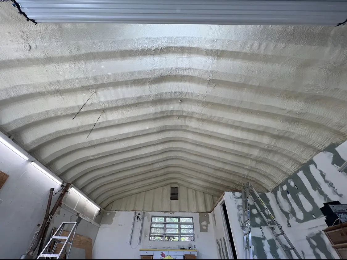Spray polyurethane foam applied to the underside of a metal roof deck in Napoleon